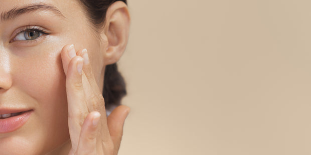 Woman adding cream on her face